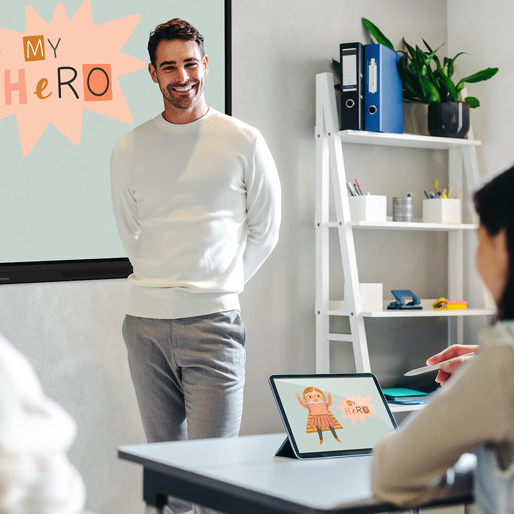A modern classroom which features an Optoma screen.  A student is mirroring what is on teh screen on their laptop whilst the teacher speaks to the classroom.